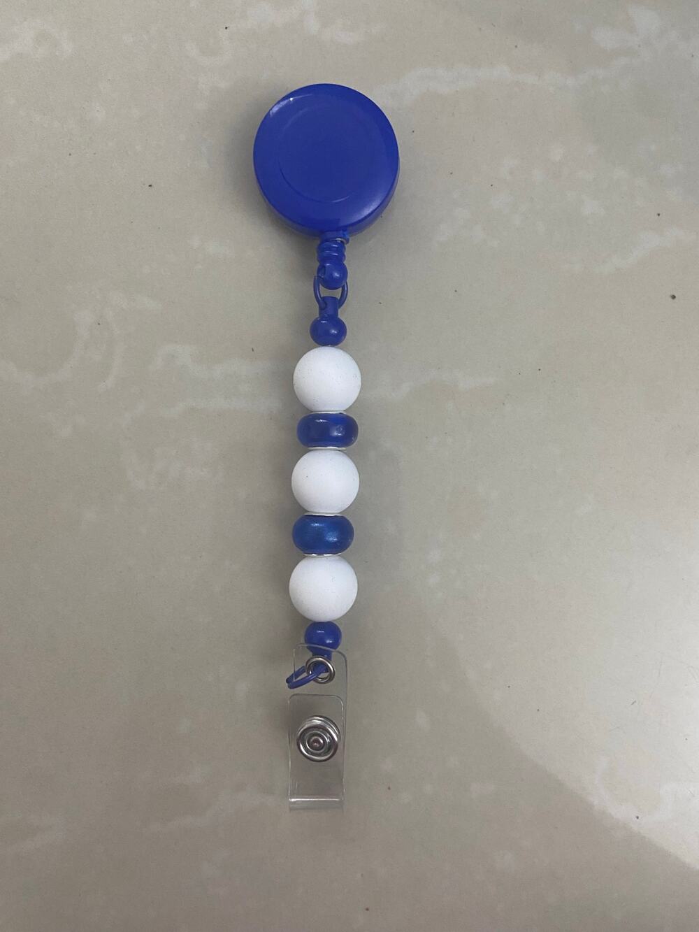 Blue and white badge reel